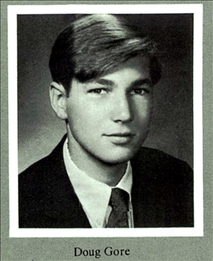 A portrait of a young white man in a suit jacket and tie